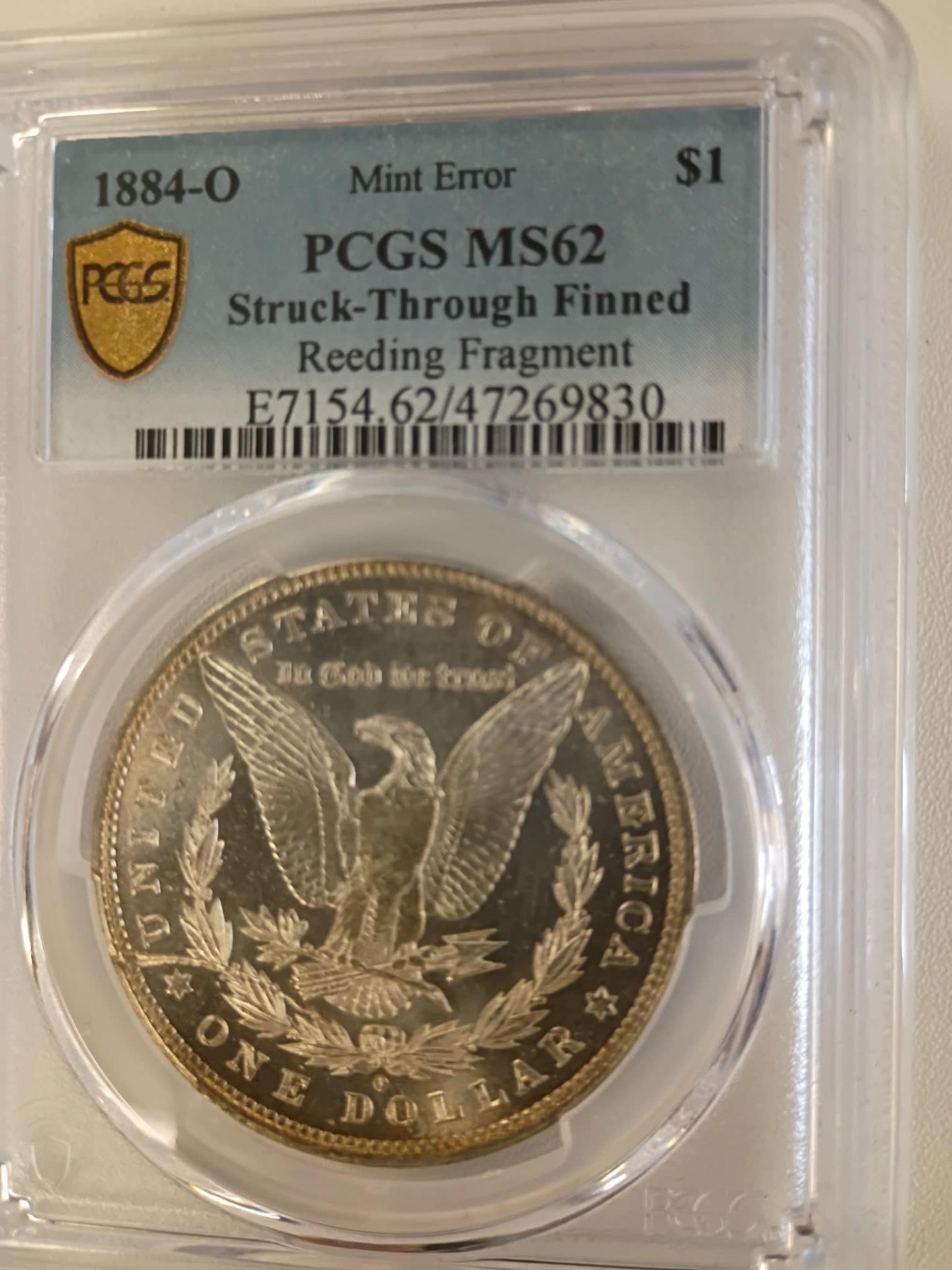 1884-O Morgan Silver Dollar | PCGS MS62 | Struck Through Finned Reeded Fragment | Mint Error | New Orleans Mint | Cert #47269830